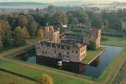 Historic Oxburgh Hall, a stunning moated manor house, offering a glimpse into Norfolk's rich heritage near Hays Wood Retreat.