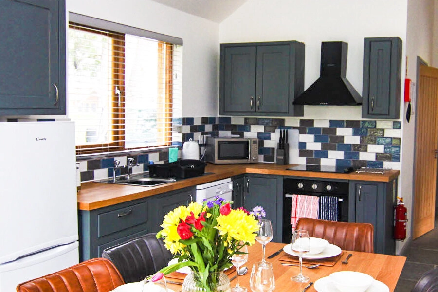 The inviting dining table in our self-catering lodge, offering a practical and stylish space for enjoying meals and socialising with guests in Norfolk.