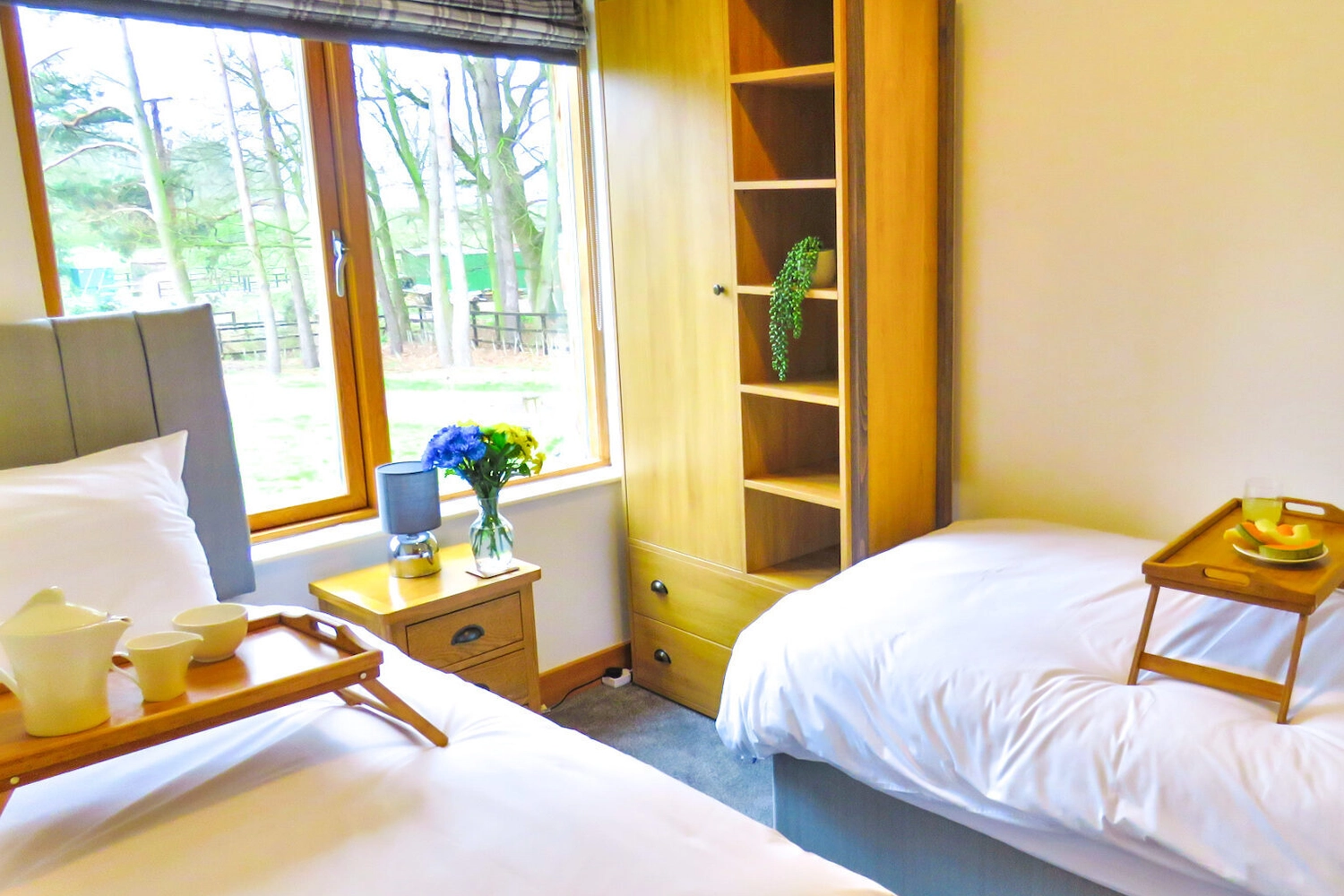 Comfortable single beds in the twin bedroom of our Hays Wood Retreat lodge, offering flexible sleeping arrangements for families and groups on a Norfolk holiday.