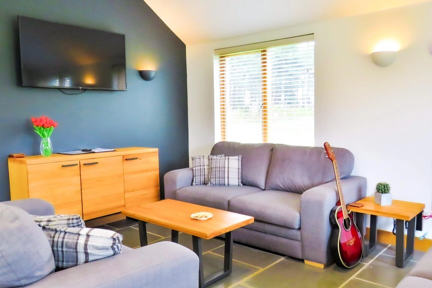 The inviting large lounge of our holiday lodge, bathed in natural light, perfect for family gatherings and unwinding after a day exploring Norfolk.